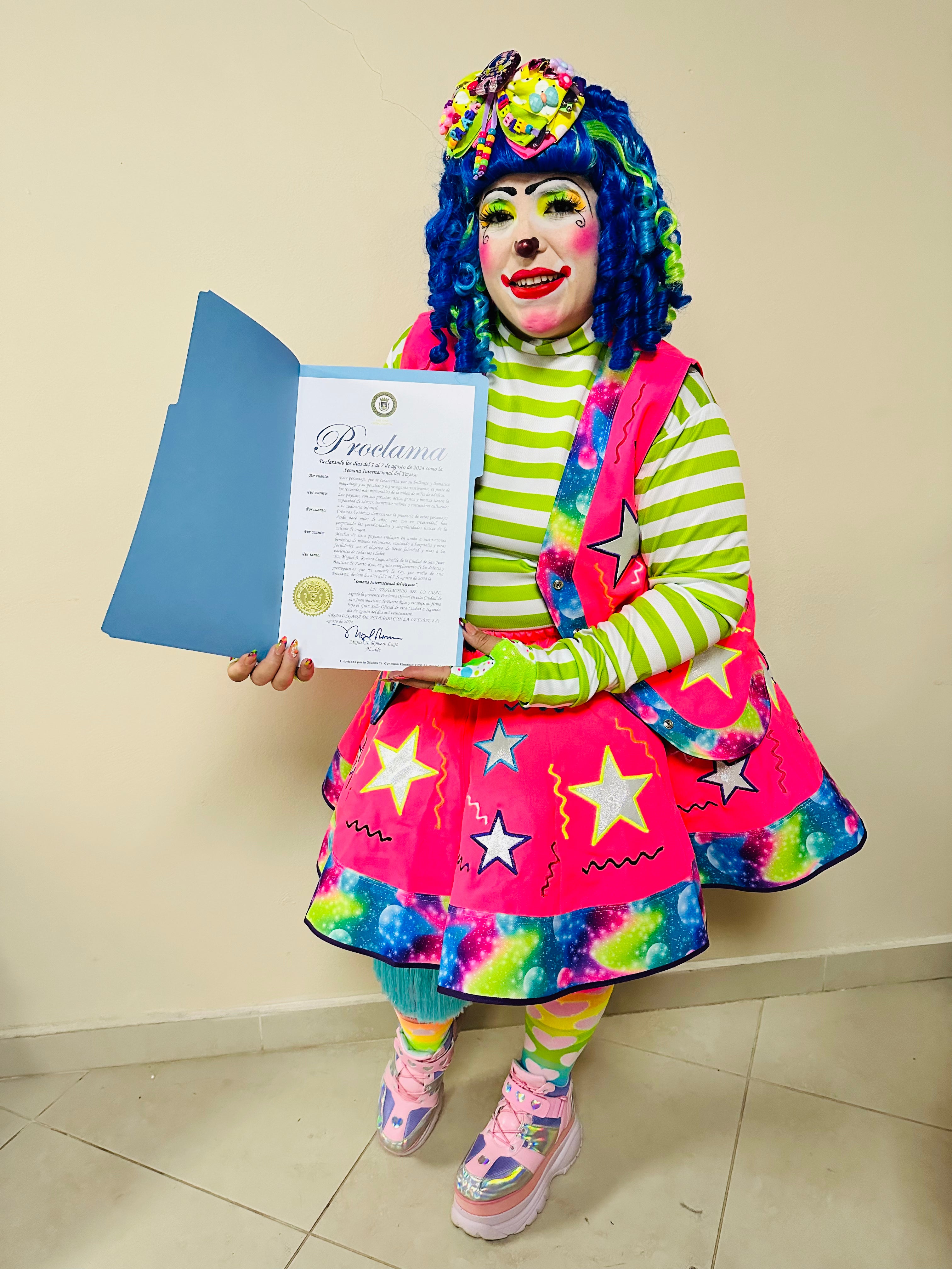 Colorful clown entertaining children at a birthday party with balloons and decorations.